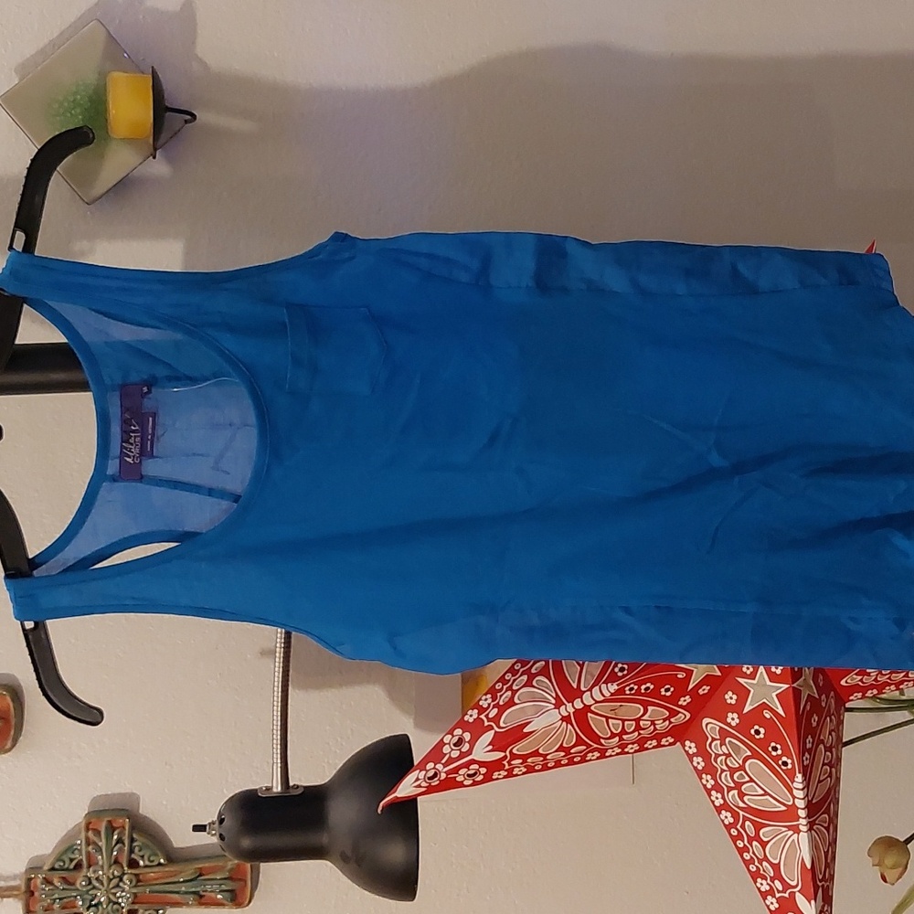 Blue racerback tank with semisheer back and small pocket on front